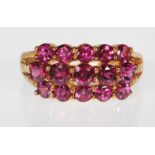 A 9ct gold (stamped 9k) Rhodolite garnet three row band dress ring, the ring set with 15 rhodolite