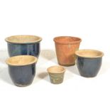 A collection of contemporary garden planters to include blue glaze examples and terracotta.
