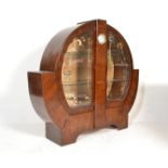 A 1930's Art Deco walnut china roundel display cabinet vitrine. The round circular cabinet with twin