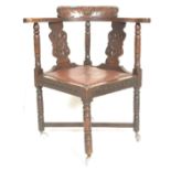 A 19th Century Victorian carved oak corner chair, the shaped rail supported by a pair of wide