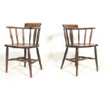 A Pair of Victorian 19th century beech and elm wood smokers bow armchairs. Raised on turned legs