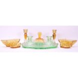 Two early 20th Century Art Deco pressed glass dressing table sets to include a part green glass