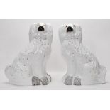 A pair of 19th Century large Staffordshire fireside dogs, white glaze with black and gold hand