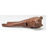 An early 20th Century black forest wooden nut cracker in the form of a bear having carved