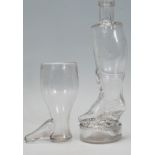 A 19th Century Georgian drink glass in the form of a boot together with a later glass decanter in