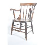 A Victorian 19th century beech and elm wood smokers bow armchair. Raised on turned legs united by