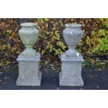 A pair of well weathered good 20th Century reconstituted well weathered stone garden campagne urn