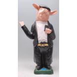 A vintage 20th Century composite novelty figurine statue in the form of a pig on its hind legs