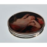 A stamped 925 silver pill pot of oval form having an enamelled lid depicting a classical female