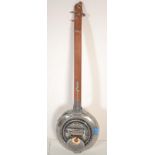 Musical Instruments: An unusual 3 string banjo  having wooden neck, shaped steel body with applied