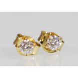 A pair of 18ct gold stud earrings set with brilliant cut diamonds of 30pts. Weight 0.9g.