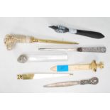 A collection of assorted letter openers to include a gilt letter opener with a ivorine dog head