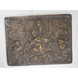 A 20th Century cast brass wall plaque having embossed decoration with a Religious mother and child