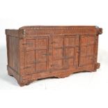 A 20th Century hardwood cupboard chest of Indian origin, carved profusely  to the front with three