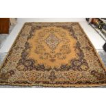 A large 20th Century large woollen floor rug on yellow ground, large central medallion panel with