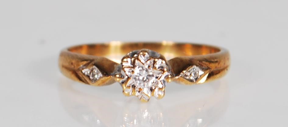 A hallmarked 9ct gold and diamond ring. The ring having a central diamond within a white and