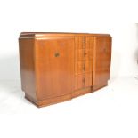 A 1930's Art Deco oak sideboard dresser of angular form. Raised on a plinth base with a central bank
