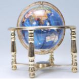 A vintage 20th Century desk top globe having a pearlescent finish, within a brass gimbal with