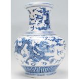 A large 19th Century Chinese blue and white centerpiece vase having bulbous form body with