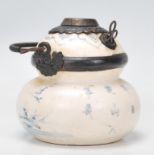 A late 19th Century double gourd ceramic incense burner having a white ground decorated with a