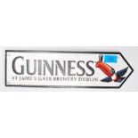 A 20th Century reproduction Guinness brewery directional advertising sign with raised lettering