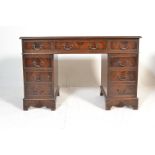 A 19th Century Victorian style twin pedestal mahogany desk, the twin pedestal having a configuration