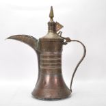 A 19th Century middle eastern Persian Islamic brass and copper coffee pot Dallah, having a elongated