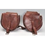 A pair of vintage 20th Century brown leather stitched saddle bags with rounded compartments having