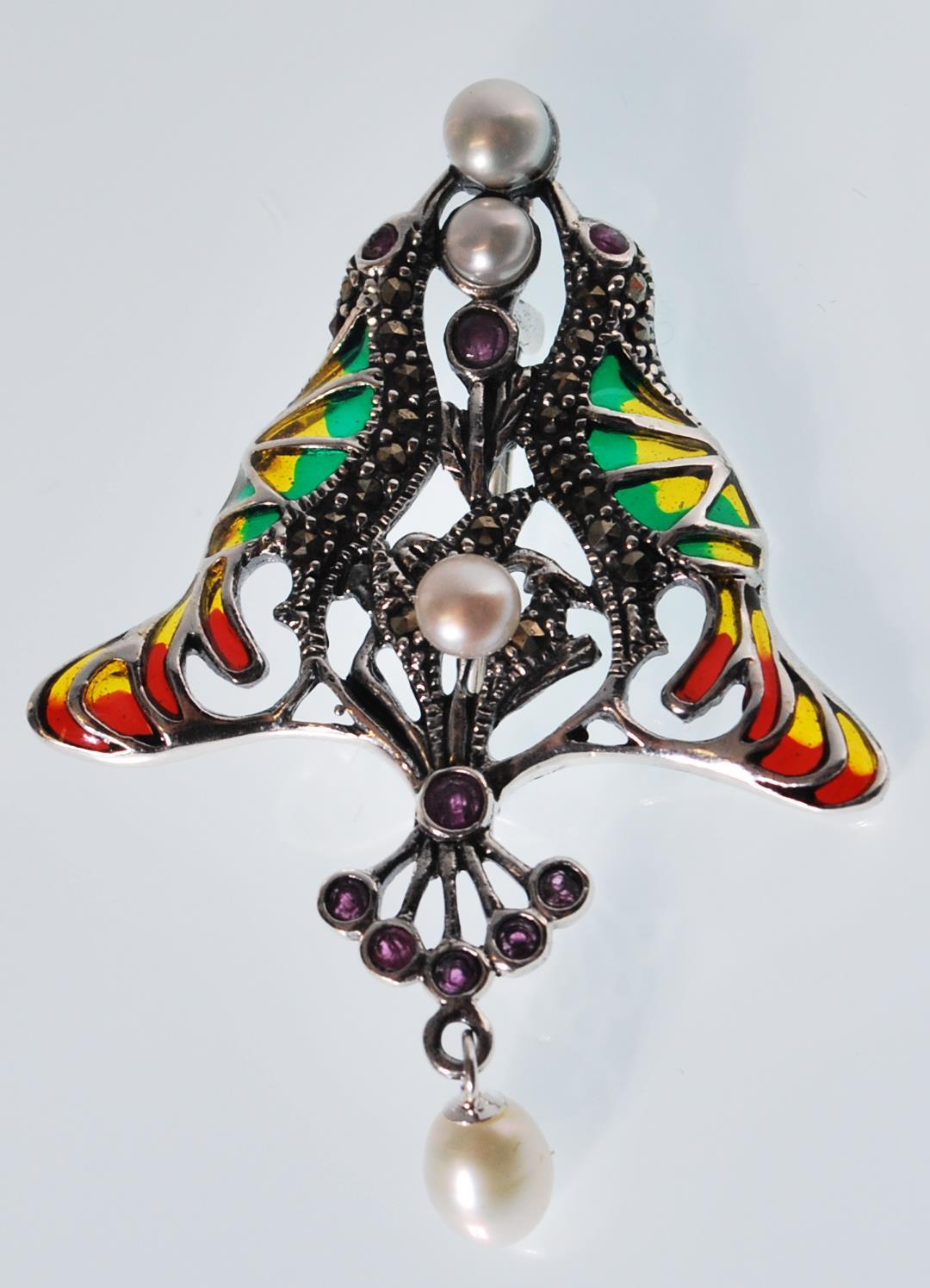 A stamped 925 silver plique a jour Art Nouveau style pendant brooch set with red stones and