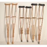 Three pairs of vintage 20th Century World War II era wooden crutches consisting of two pairs of