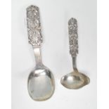A 20th Century silver serving spoon having scrolled and pierced foliate decoration and a feeding