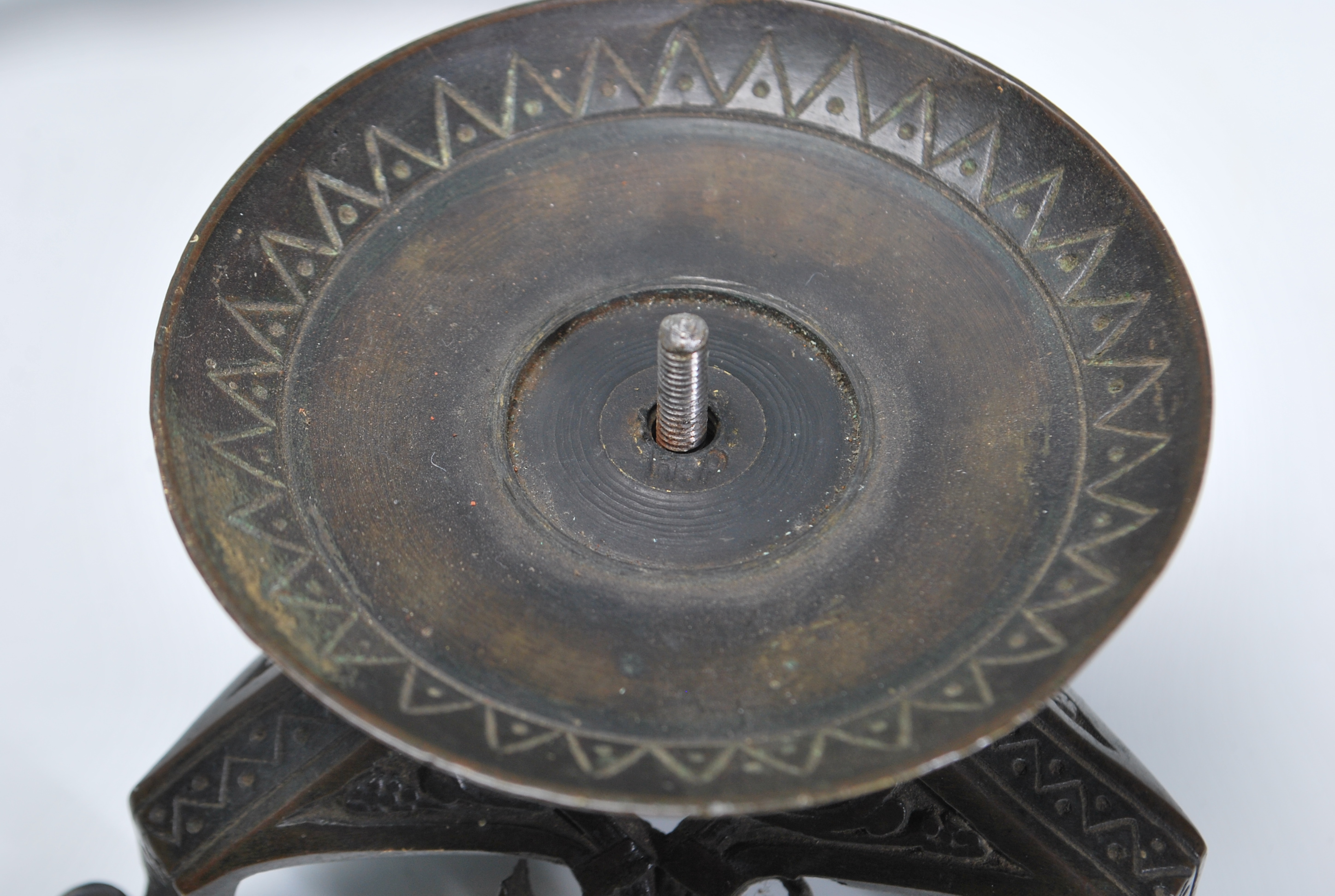 A late 19th / early 20th Century Arts and Crafts case bronzed candlestick raised on a tripod base - Image 7 of 7
