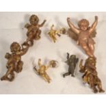 A group of three vintage 20th Century gilt wood hanging musical cherubs together with a matching