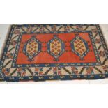 A 20th century Persian / Islamic tribal rug having vivid colours with central red ground having 3