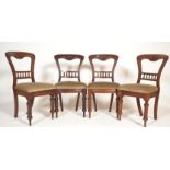 A set of 4 Victorian 19th century mahogany kidney / balloon back dining chairs. Raised on turned