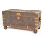 A mid century Chinese camphor wood blanket box trunk. Of rectangular form with brass bound corner