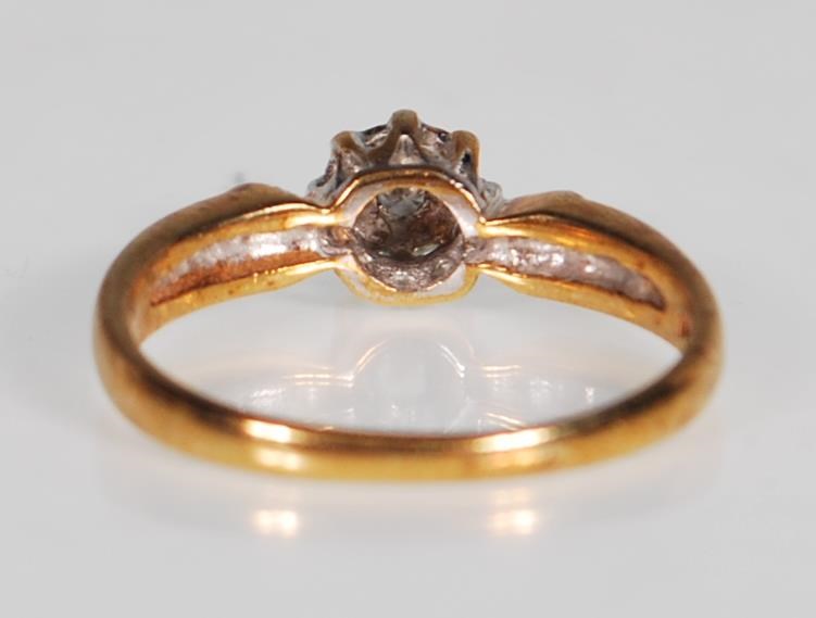 A hallmarked 9ct gold and diamond ring. The ring having a central diamond within a white and - Image 3 of 6
