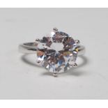 A stamped 925 silver solitaire ring set with a large round cut CZ. Weight 5.4g. Size P.