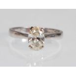 A stamped 18ct white gold diamond solitaire ring set with an oval cut diamond. Diamond estimated 1.