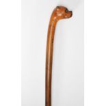 A 19th Century child's walking stick cane of tapering form having the top carved in the form of a