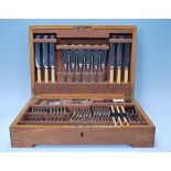 An early 20th century oak cased Elkington canteen of cutlery having 12 place setting. Brown baize