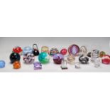 A large collection of various designed paperweights by various makers to include several