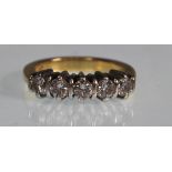 A stamped 18ct white gold five stone ring set with five round cut diamonds. Diamonds estimated