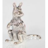 A silver pin cushion in the form of a kangaroo having a red velvet cushion to its back. Measures 4.
