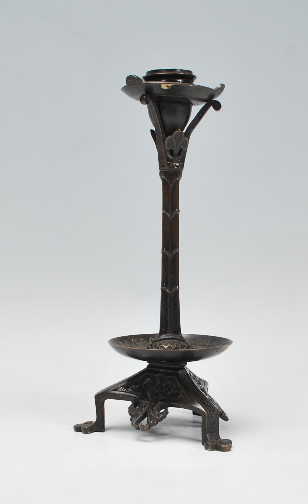 A late 19th / early 20th Century Arts and Crafts case bronzed candlestick raised on a tripod base - Image 2 of 7