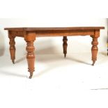 A 19th Century Victorian oak extendable dining table, flared canted frieze raised on turned baluster
