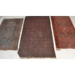A  collection of Persian / Islamic rugs to include a red ground Bokhara rug with multiple medallions
