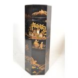 A 20th Century hexagonal Chinese chinoiserie pillar / stand / pedestal base having a black lacquer