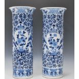 A good pair of 19th Century blue and white vases of cylindrical form having flared rims. Each vase