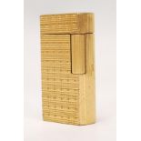 A vintage 20th Century Dunhill model no. 70 gas lighter of rounded oblong form with gold plated